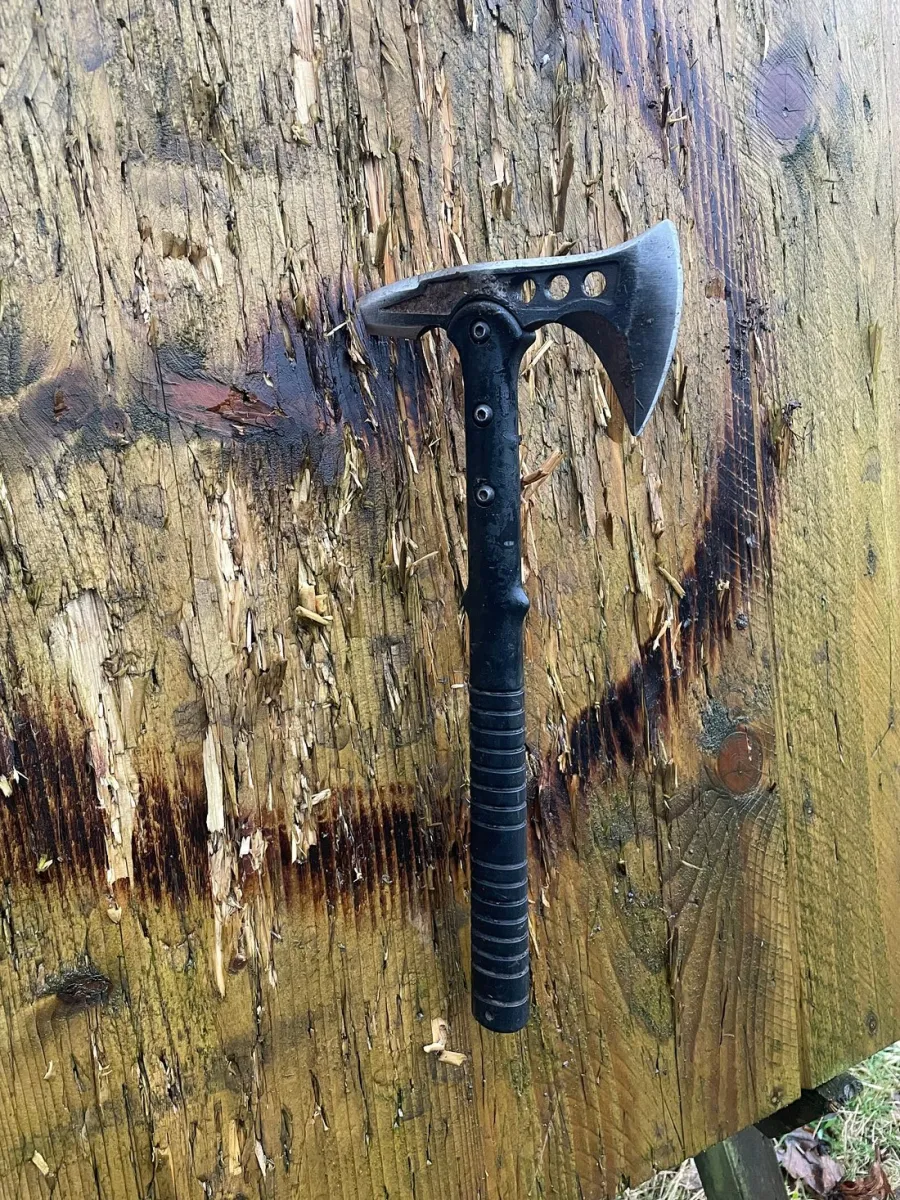 A tomahawk embedded in a wooden target.