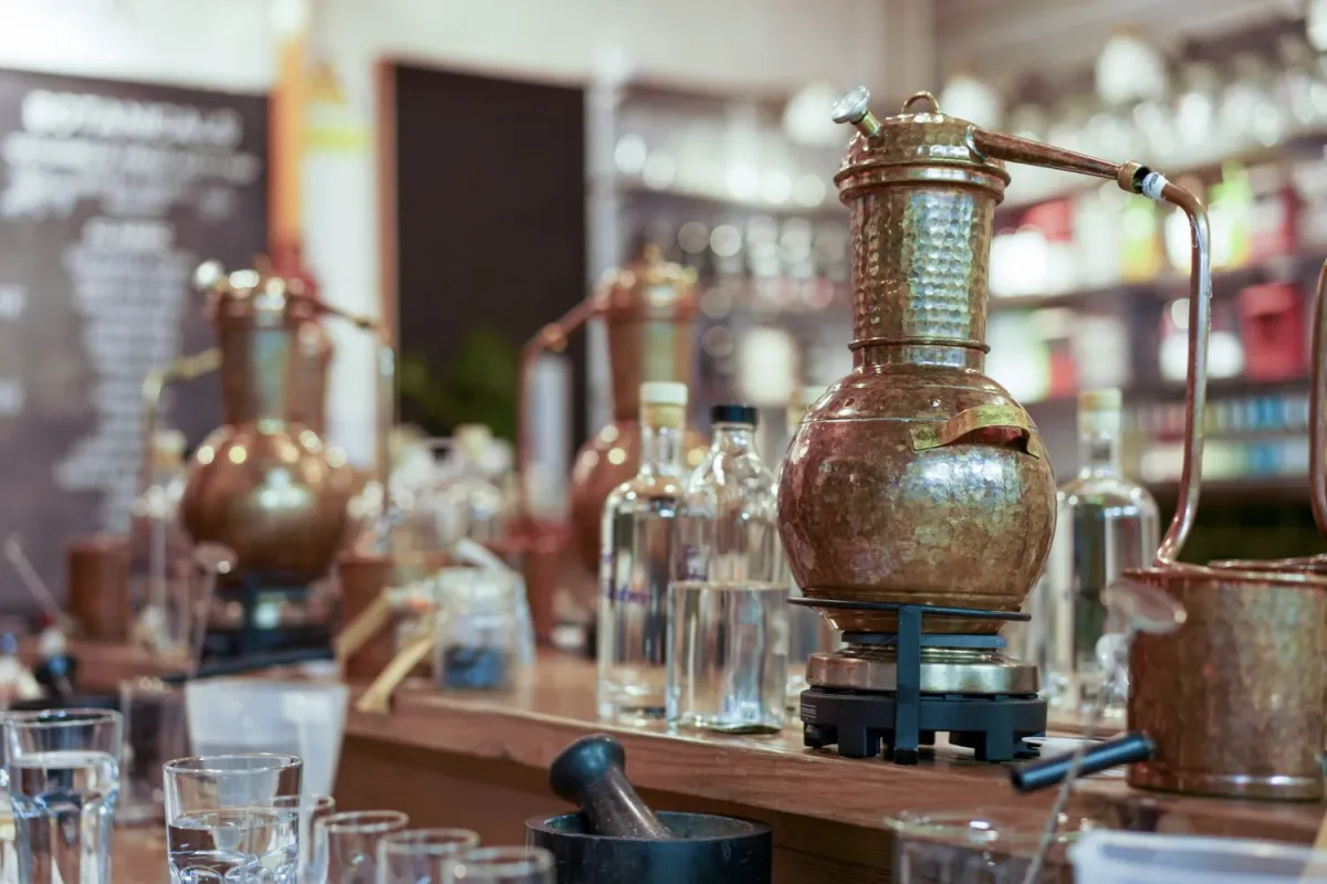 Copper distillation equipment on a wooden counter.