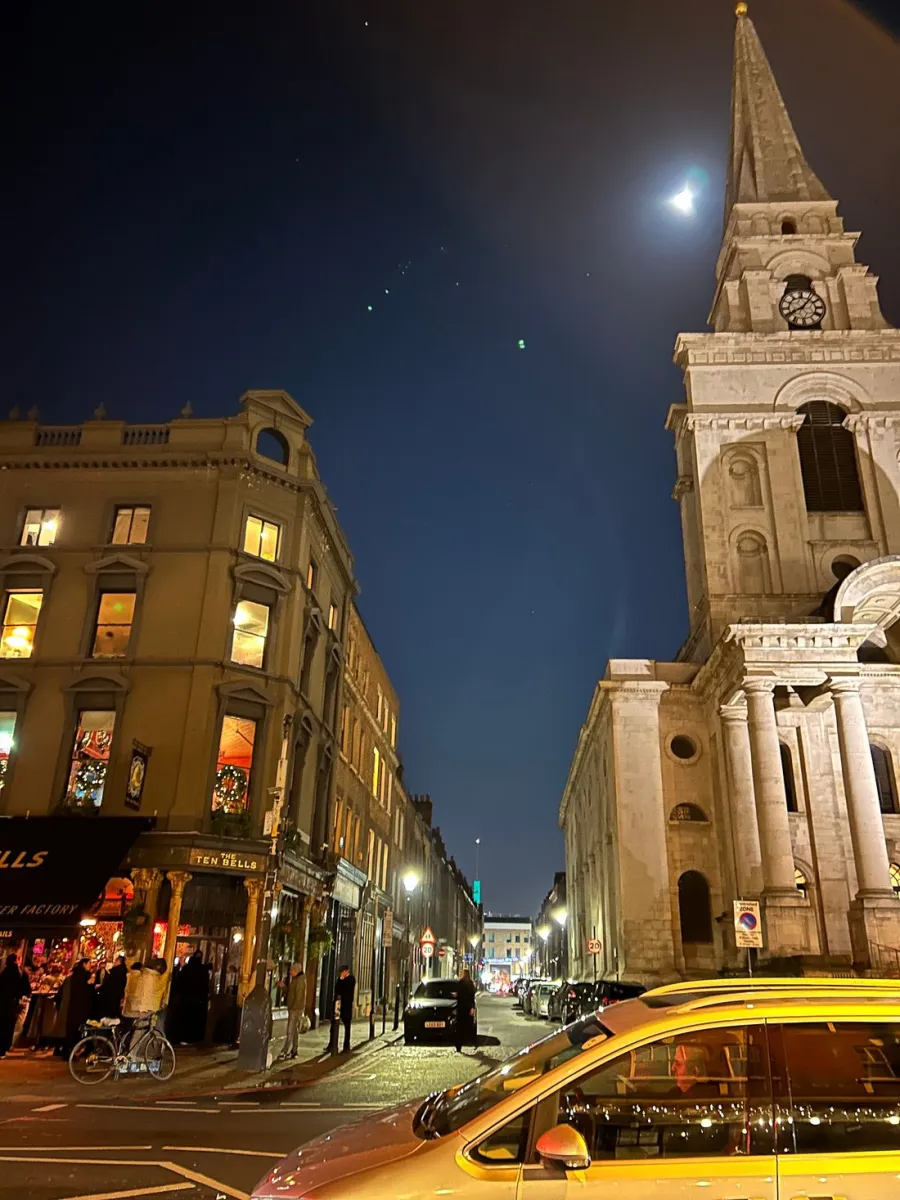 Night street scene with a church and buildings