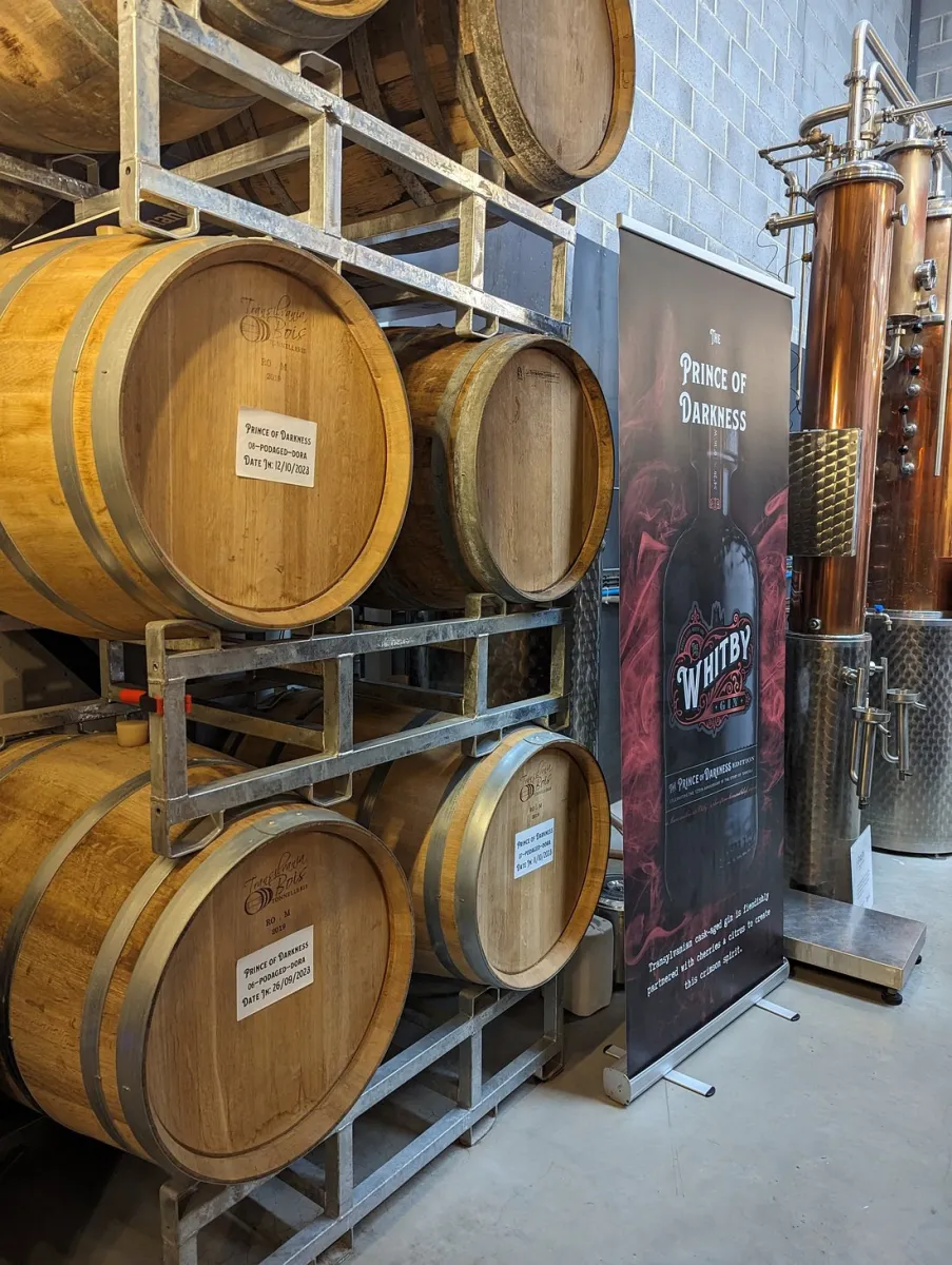 Wooden barrels and a distillery banner.