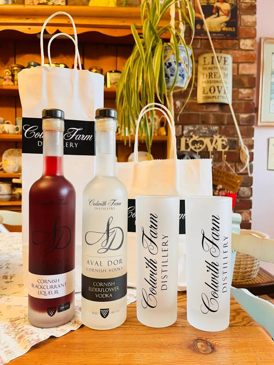 Two bottles of Colwith Farm spirits with branded glasses.