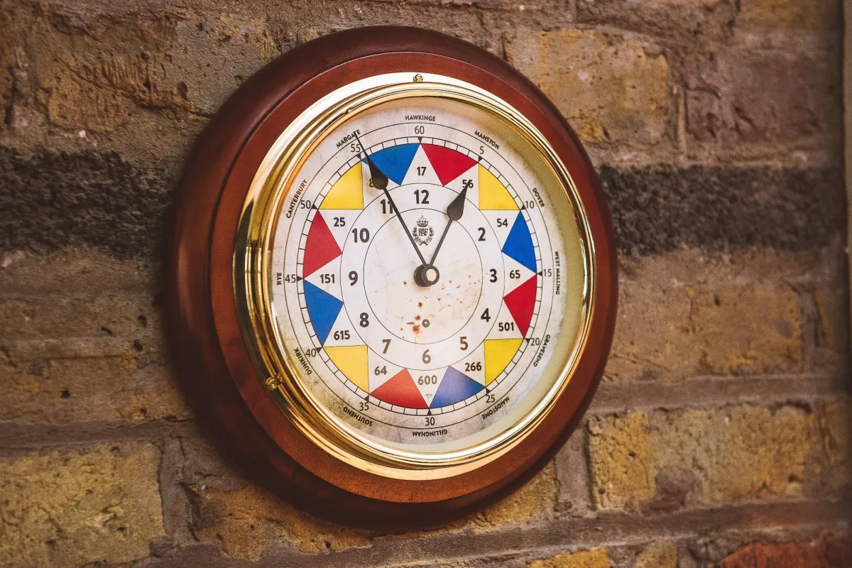 Colorful vintage clock on a brick wall