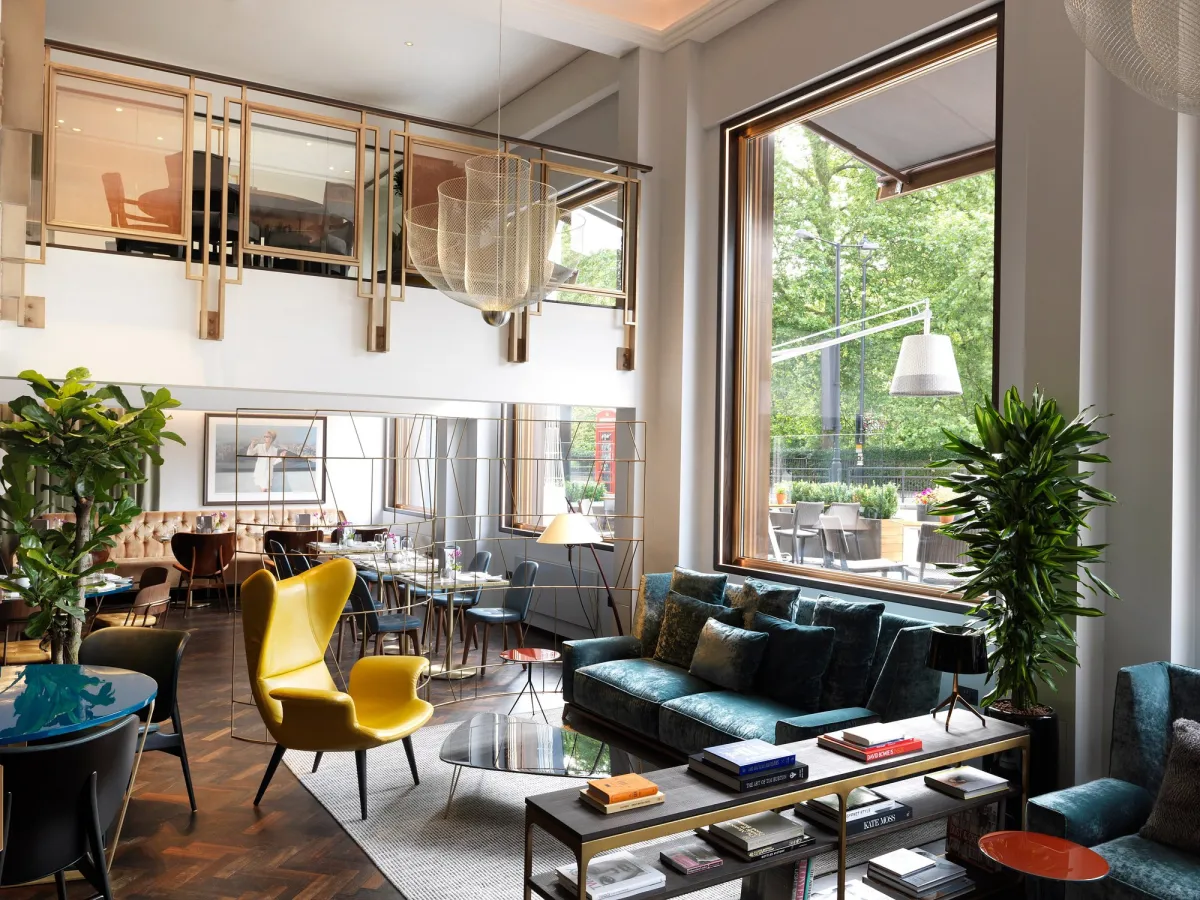 Modern lounge with large window and stylish furniture.