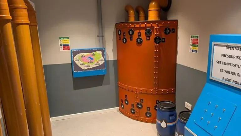 Room with industrial equipment and control panels.