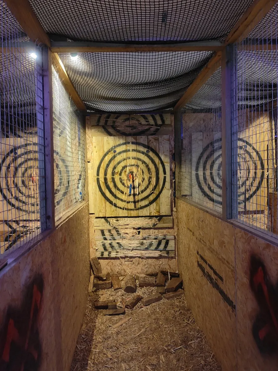 Axe throwing lane with wooden targets.