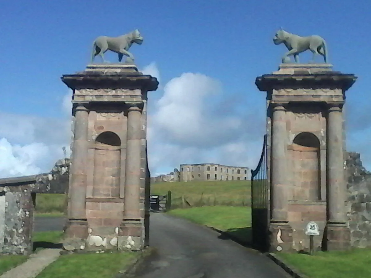 Stone gate with animal statues and distant building