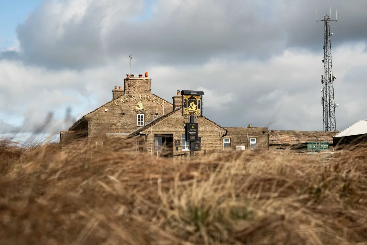 Stone building with Cat & Fiddle sign