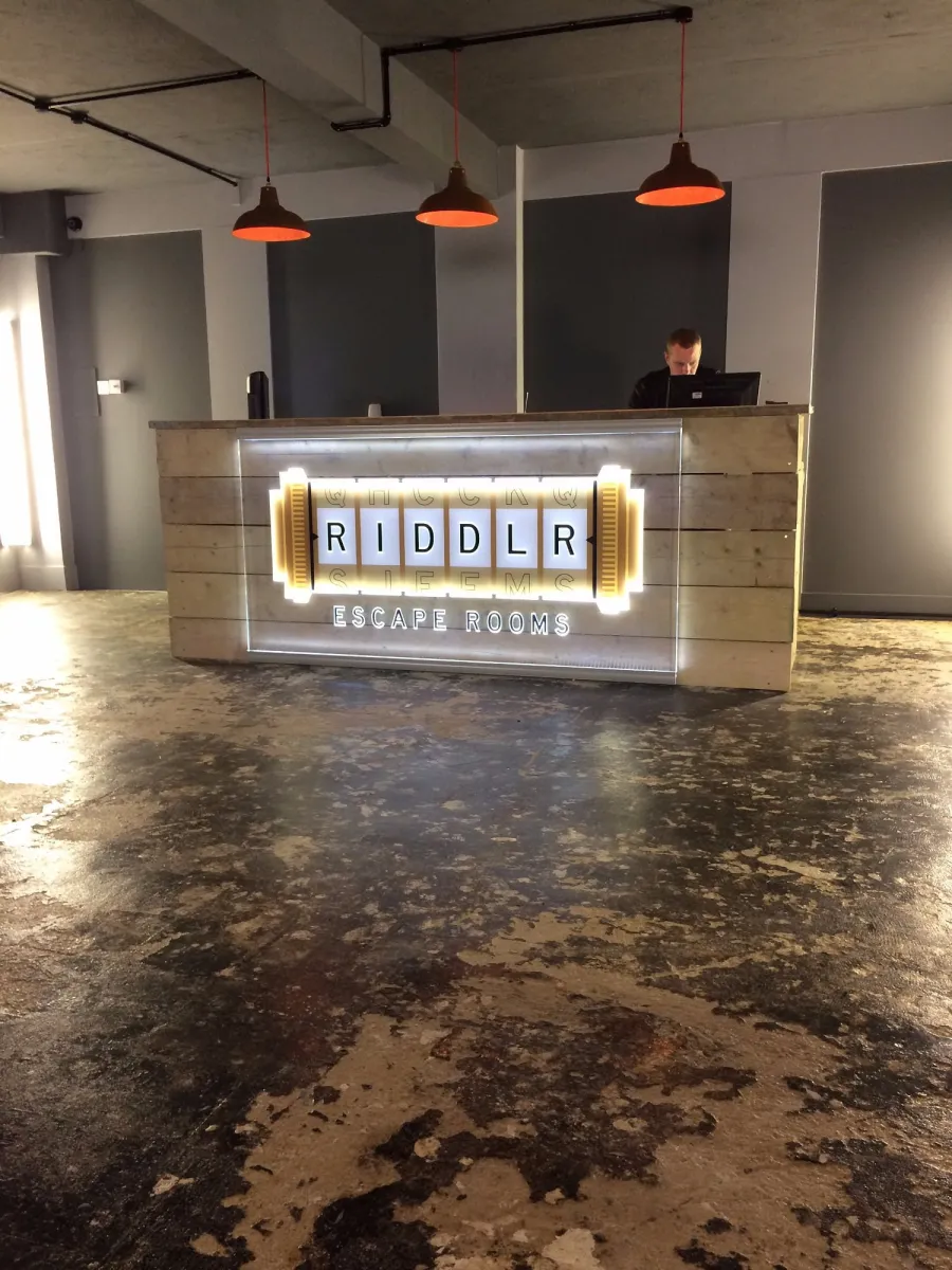 Reception desk at Riddlr Escape Rooms.