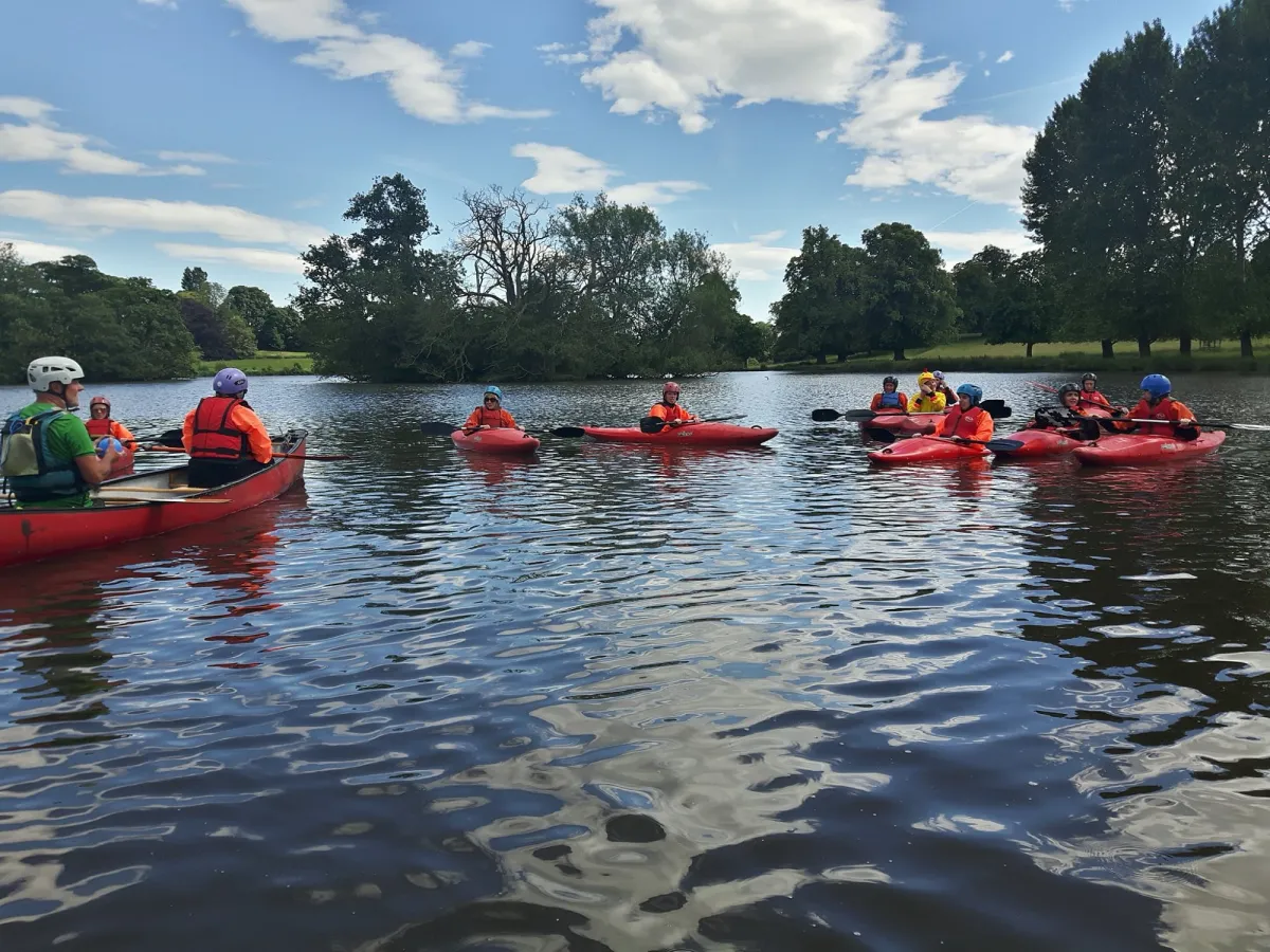 Group kayaking on a calm lake.