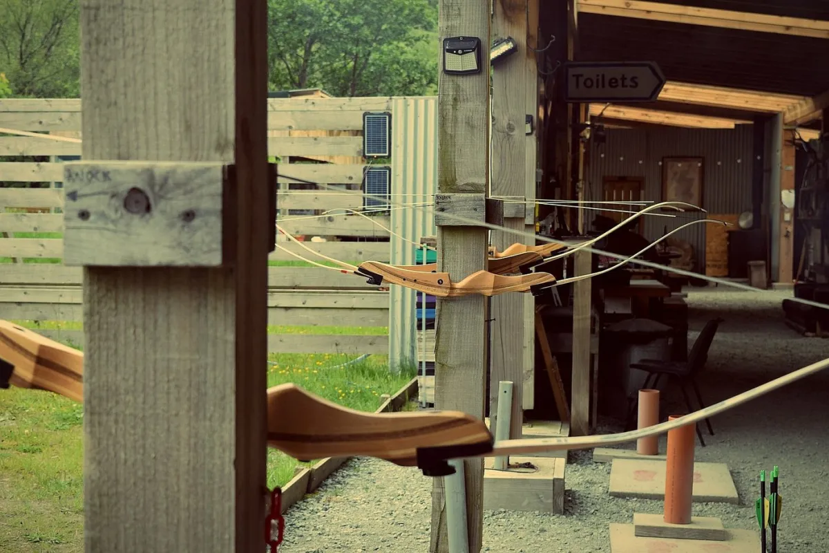 Archery range with bows and arrows lined up.