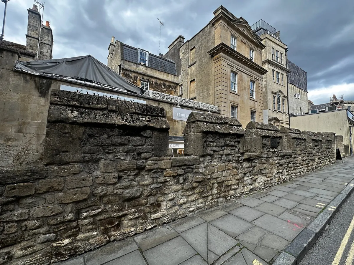 Historic stone wall with buildings in the background