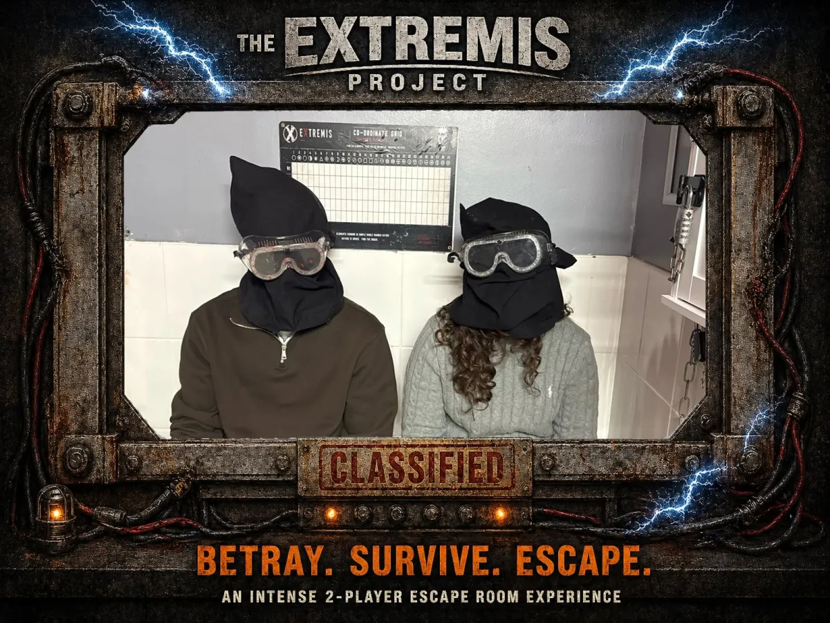 Two people in dark hoods and goggles in an escape room.