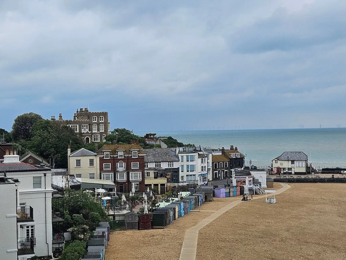 Coastal town with beach and buildings.