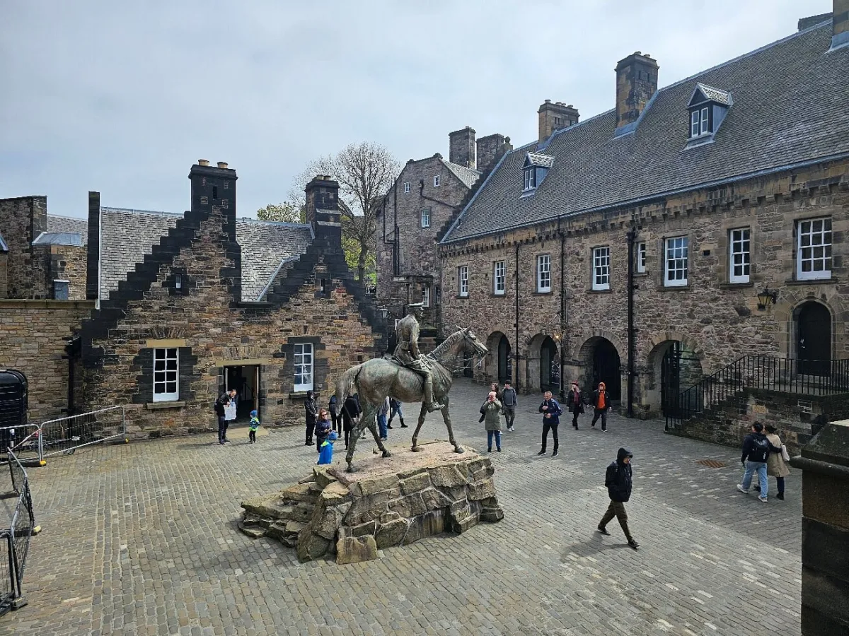 Statue of a rider on horseback in a historic courtyard