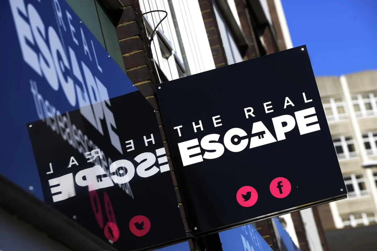 Sign for The Real Escape with social media icons