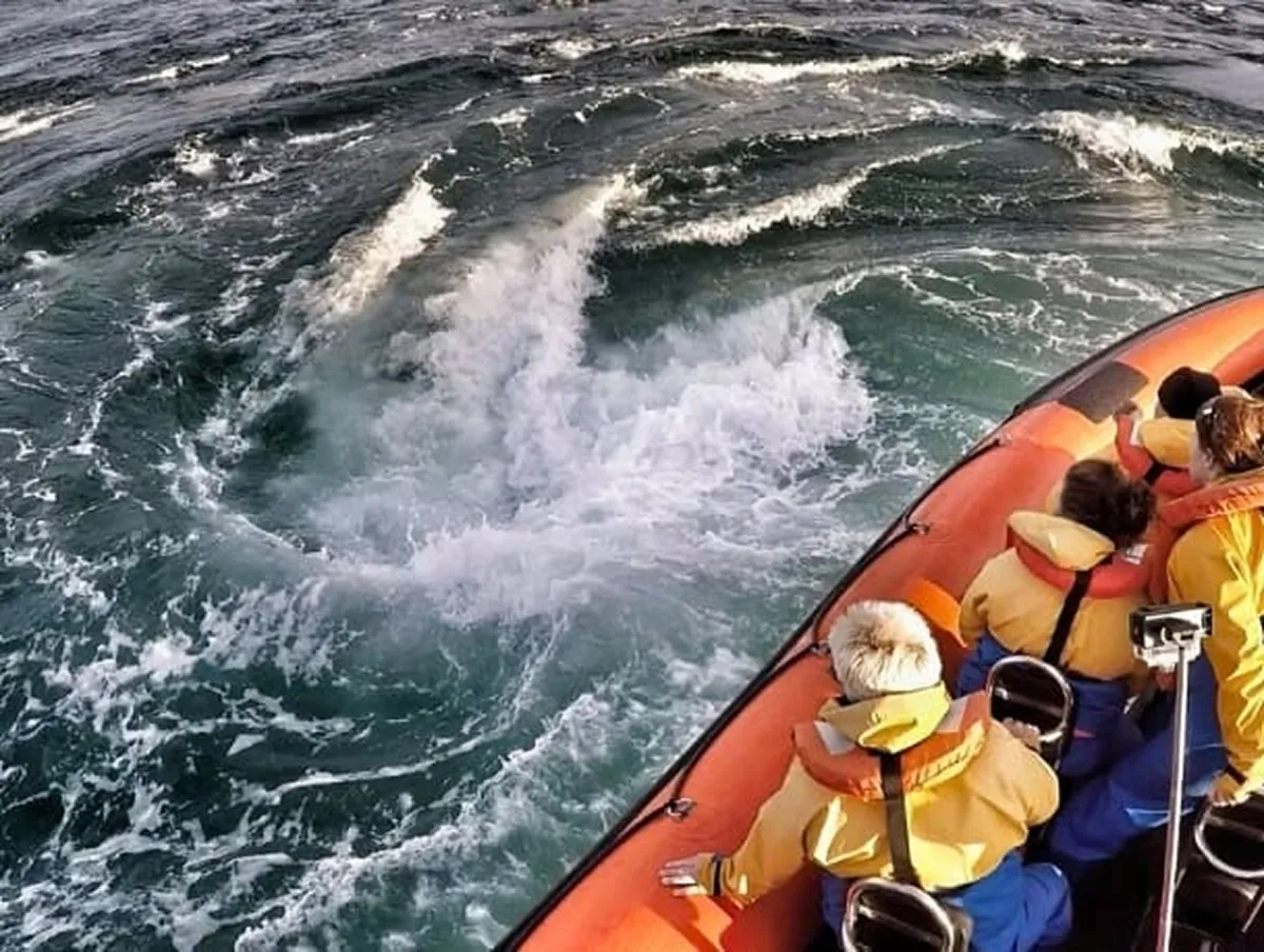 People on a boat near swirling ocean waters