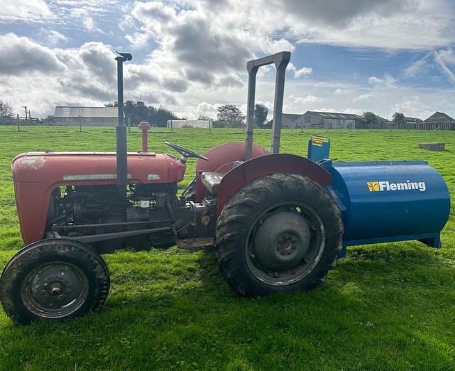 Fleming mini-muck compact muck spreader attached to a small tractor