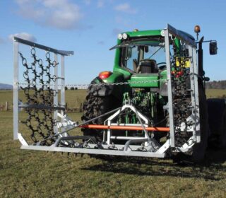 Ritchie 6m Hydraulic Folding Harrow mounted on a tractor