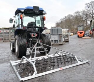 Ritchie 2.2m Harrow mounted on a compact tractor.