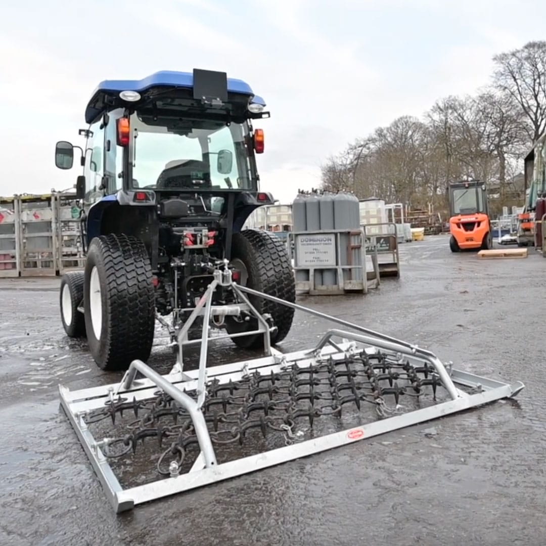 Ritchie 2.2m Harrow mounted on a compact tractor.
