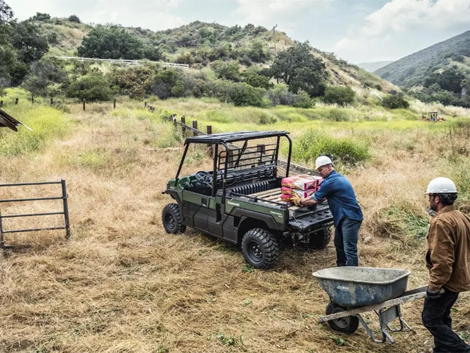 Man loading up a Kawasaki Mule Pro-DX UTV