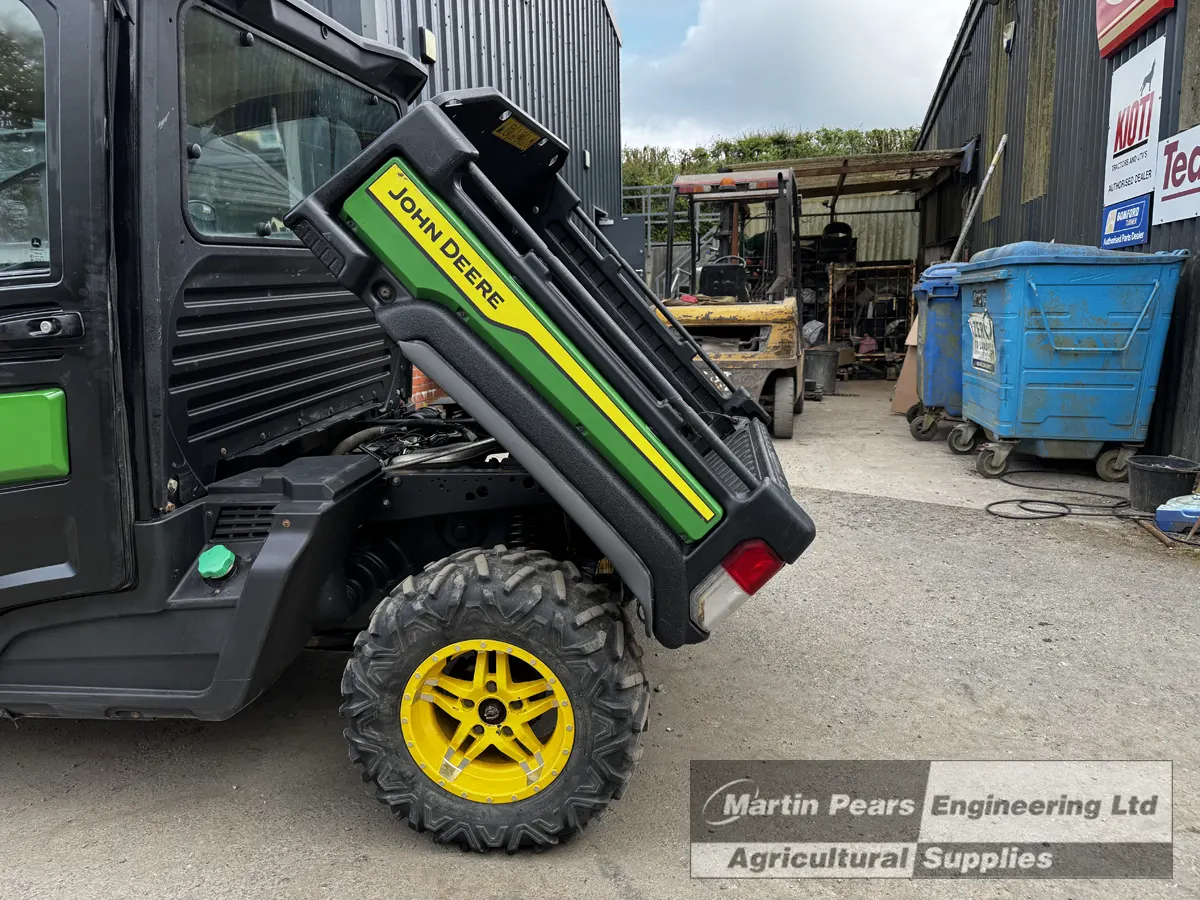 Jon Deere Gator 4x4 UTV with cargo bed tipped
