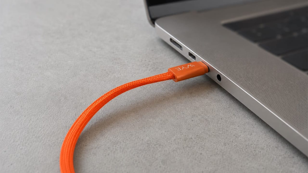 Orange WYE 240W USB-C cable connected to a laptop
