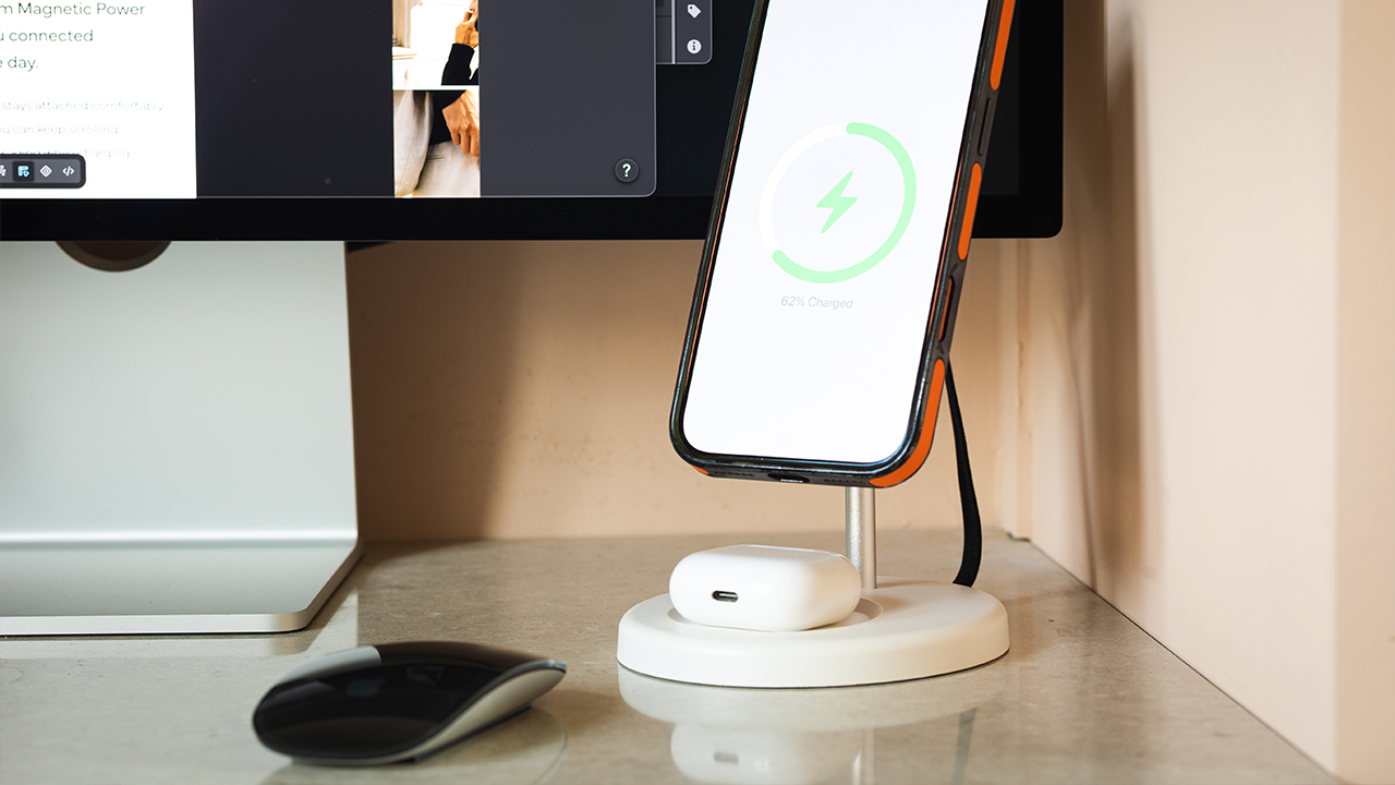 WYE wireless charging stand charging a phone and earbuds